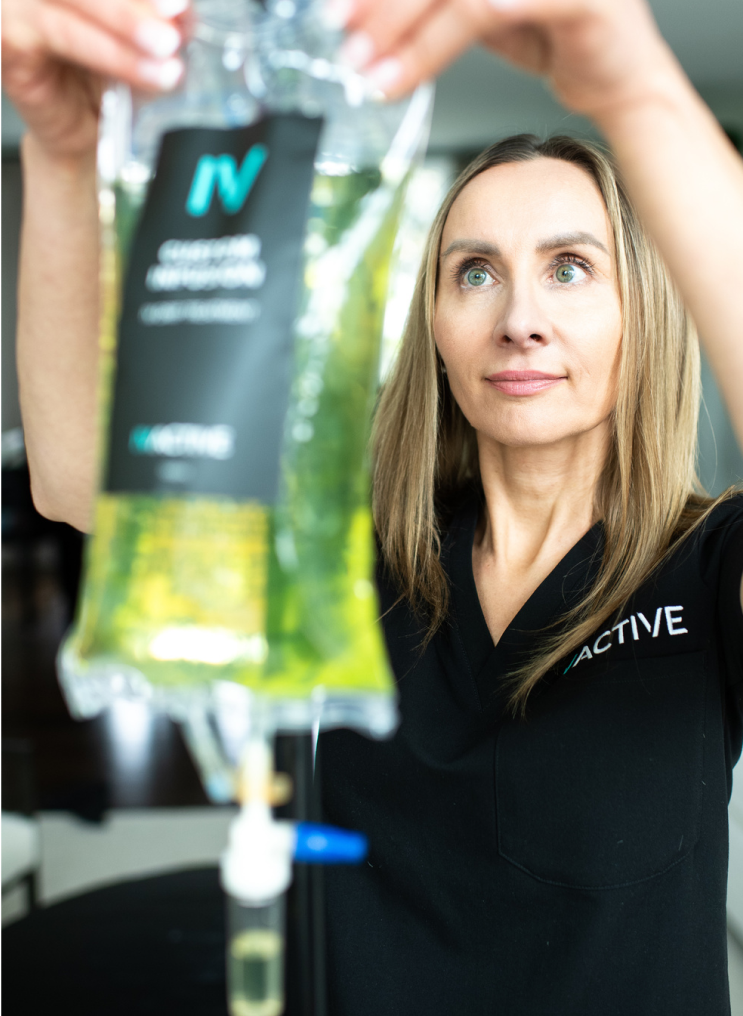 An IV ACTIVE registered nurse hanging a custom infusion IV drip bag.