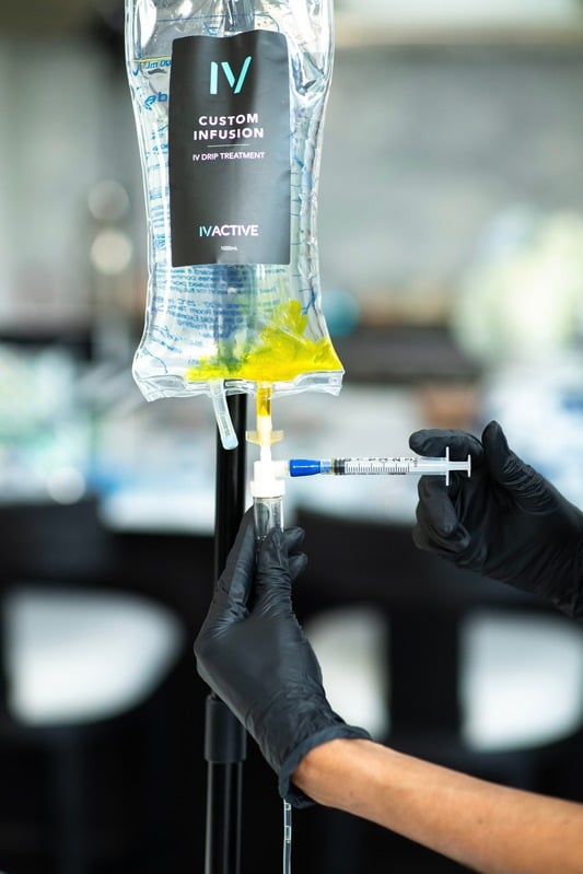 An IV ACTIVE nurse preparing a personalized IV drip treatment.